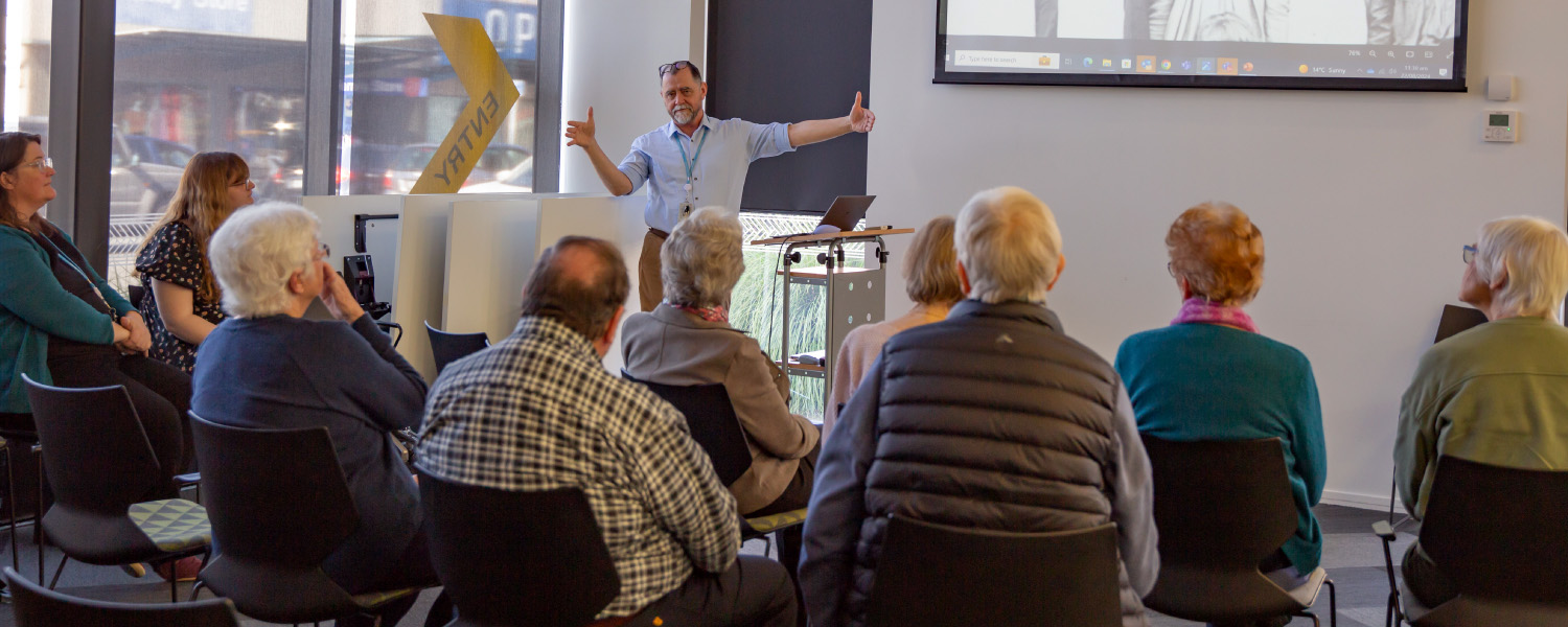 Community group members attend a library presentation.
